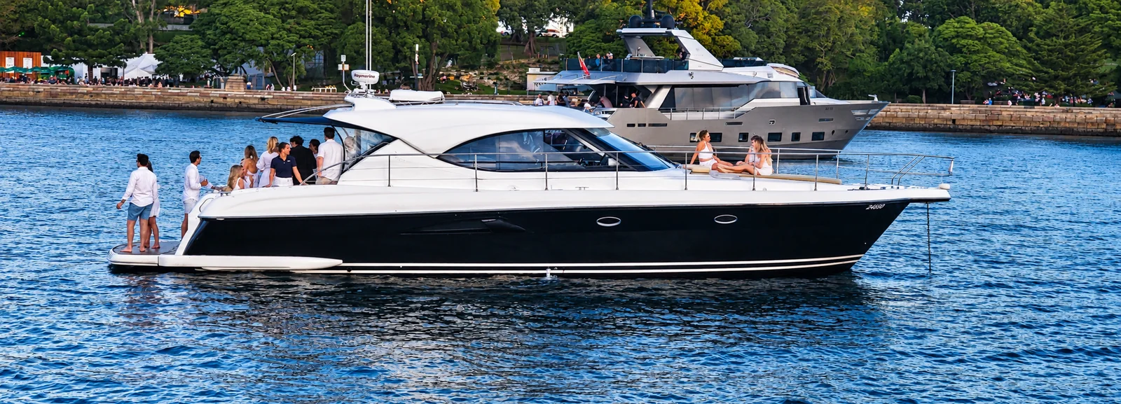 SEADUCTION Riviera charter boat with guests enjoying the decks on Sydney Harbour