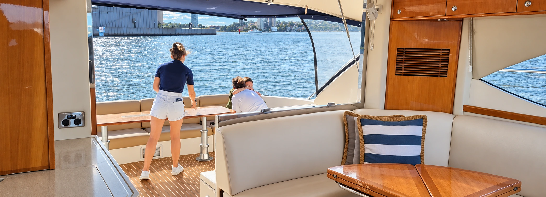A stewardess looking after a couple on SEADUCTION’s connected saloon and aft deck