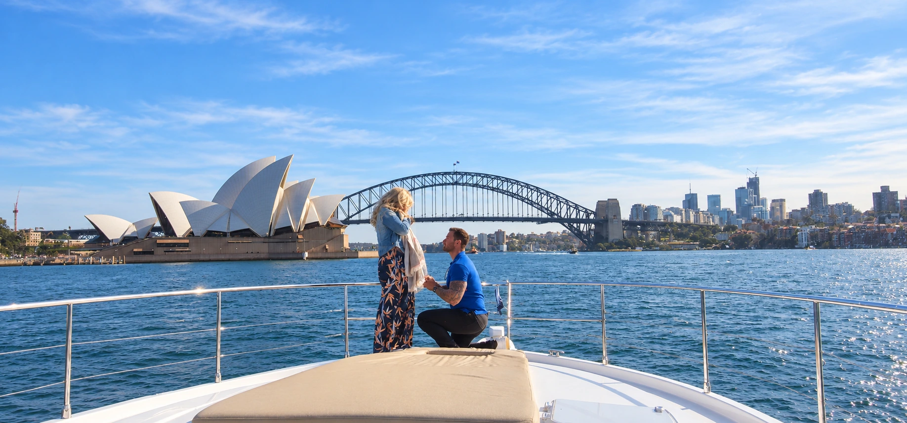A marriage proposal on SEADUCTION’s bow with the Sydney Opera House and Harbour Bridge behind the couple